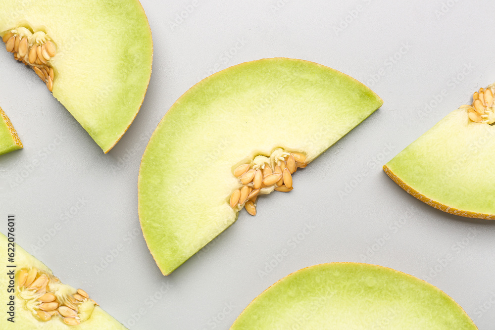 Pieces of sweet melon on grey background