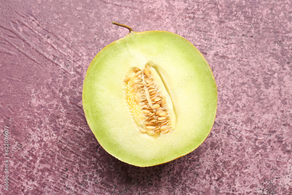 Half of sweet melon on purple background