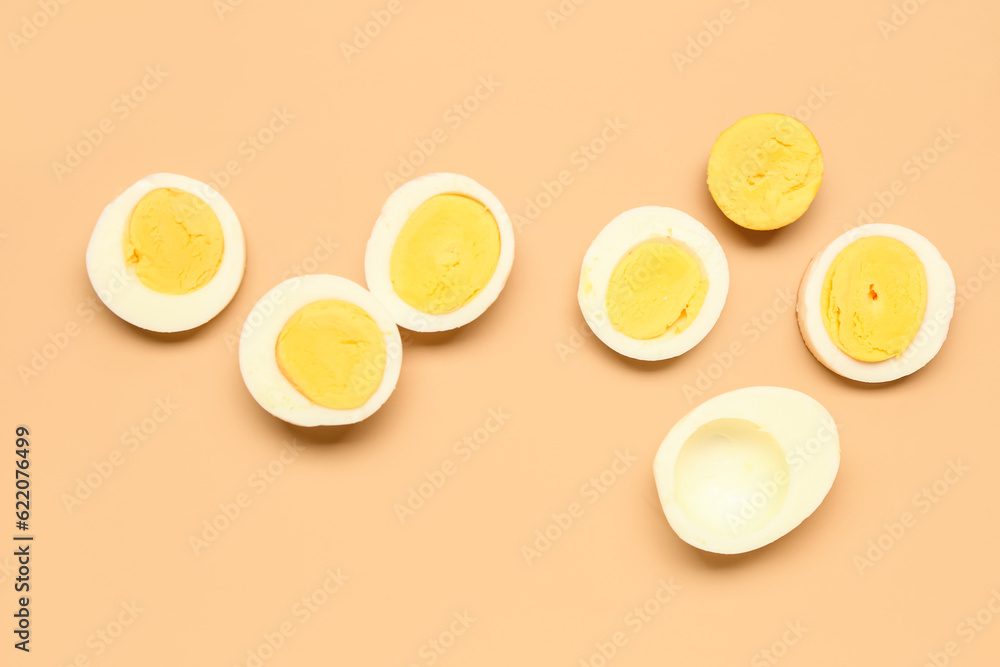 Slices of tasty boiled eggs on orange background