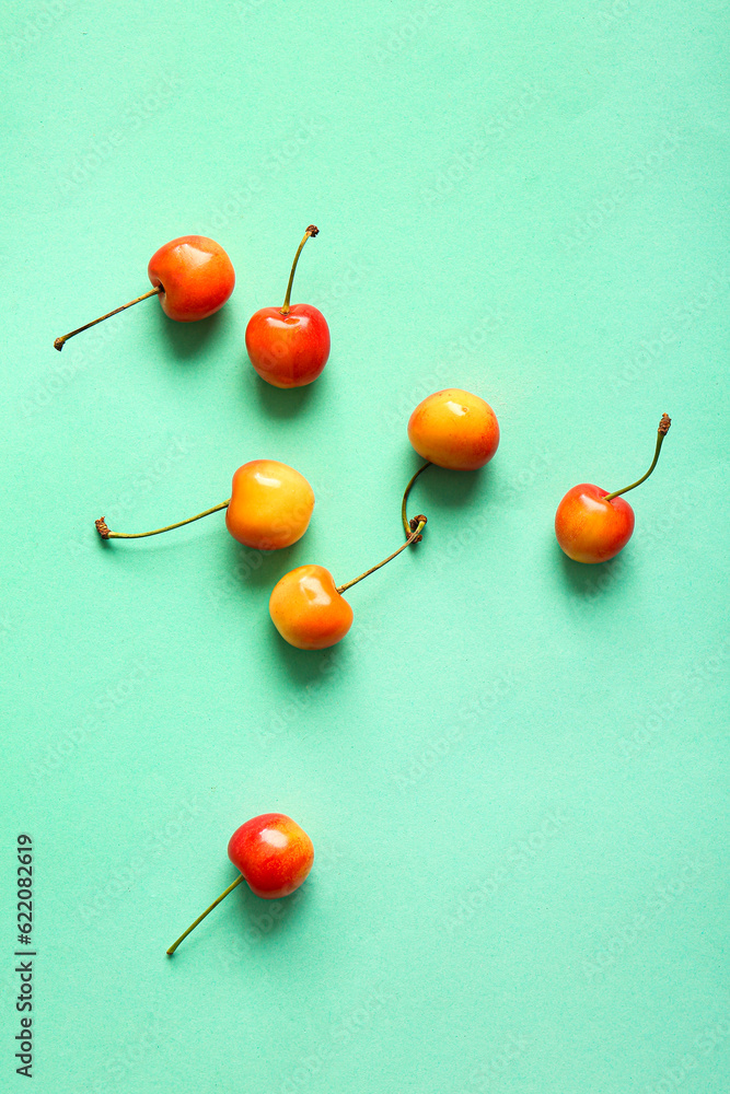 Sweet yellow cherries on turquoise background