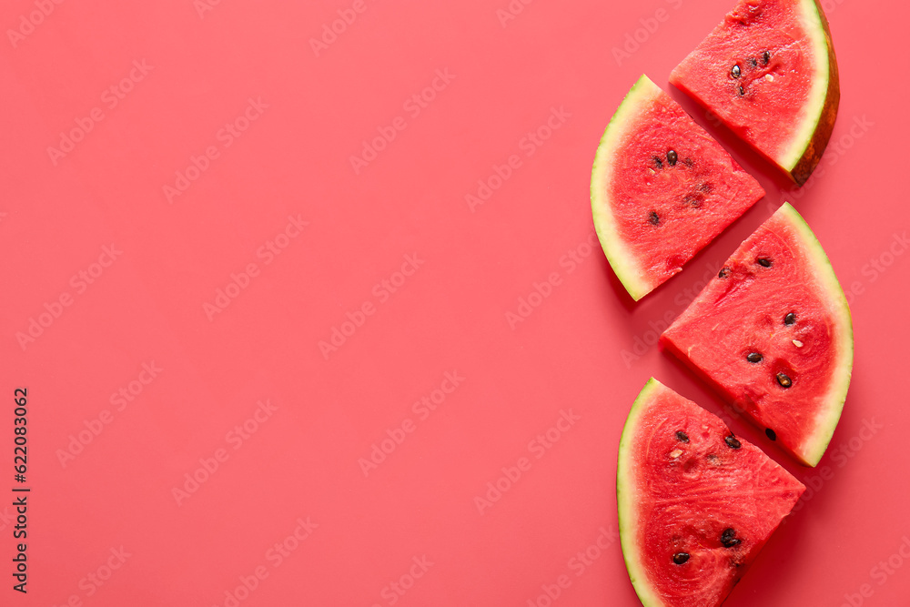 Pieces of fresh watermelon on red background