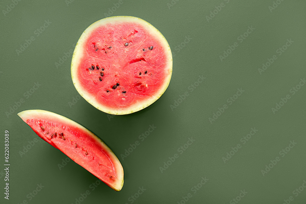 Half of fresh watermelon with piece on green background