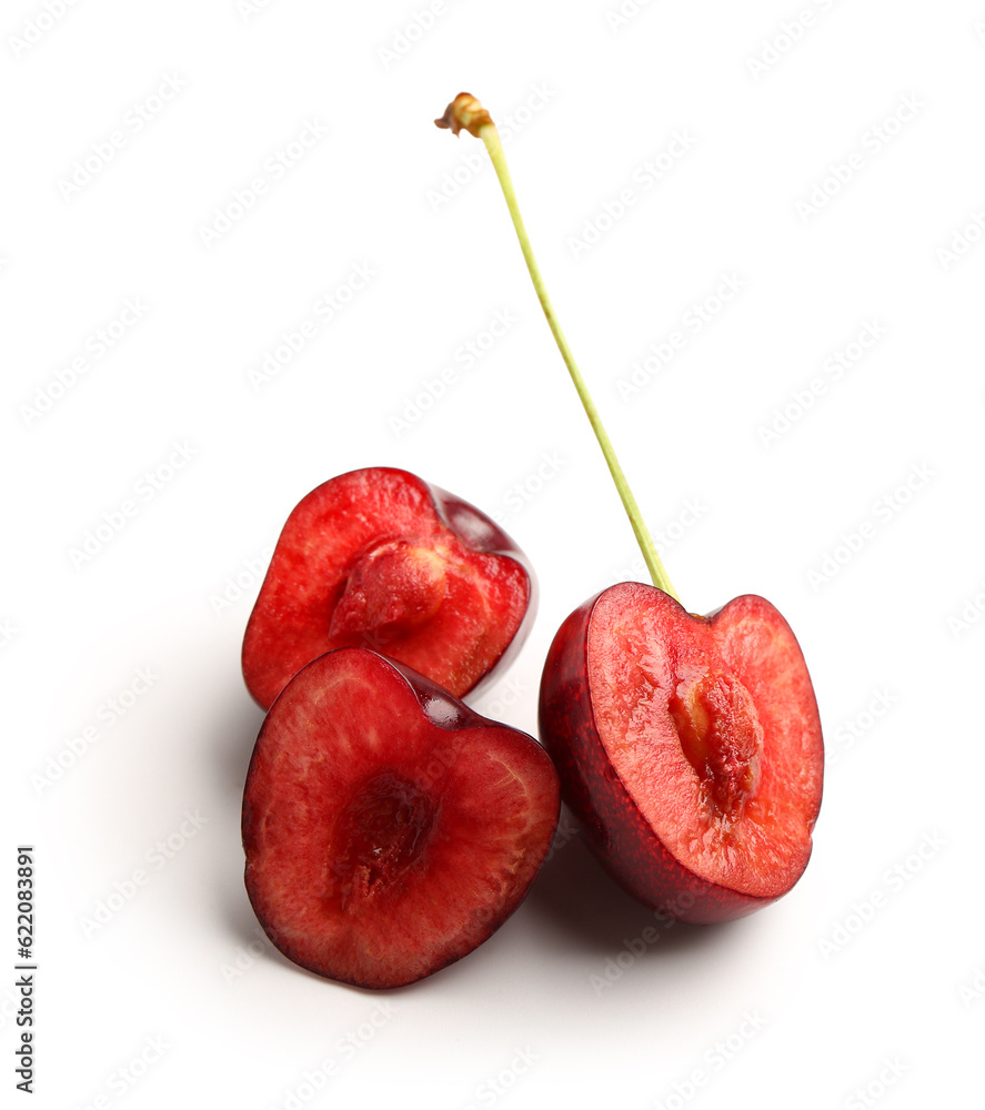 Halves of red sweet cherries on white background