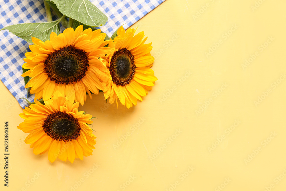 Beautiful sunflowers on yellow background