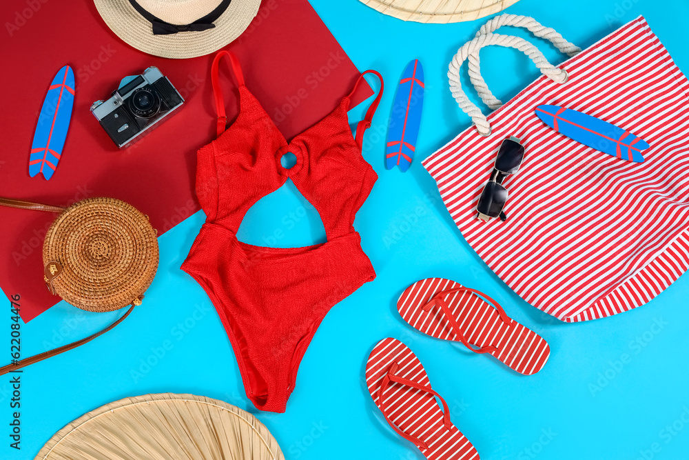 Different beach accessories on blue background. Travel concept