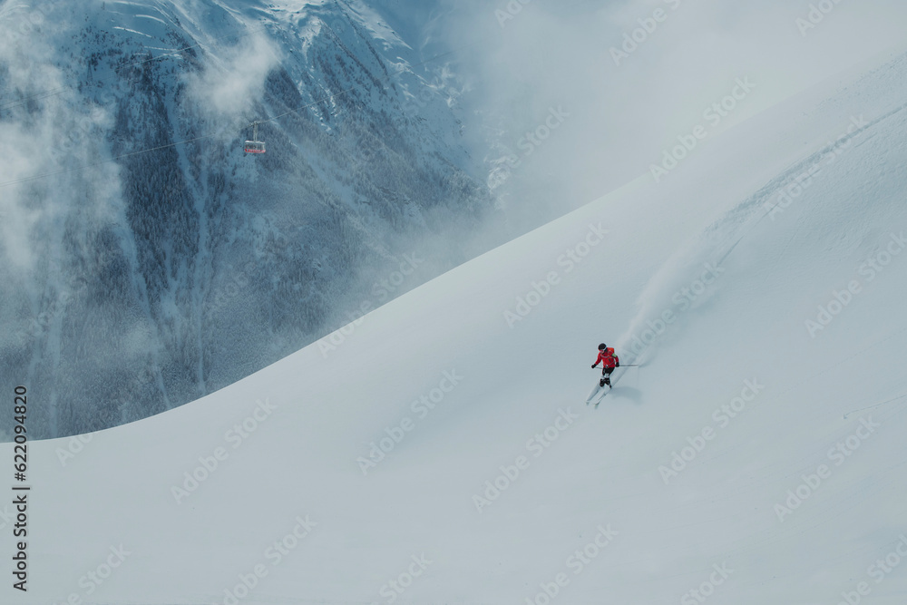 skier on the slope with mountains in the background