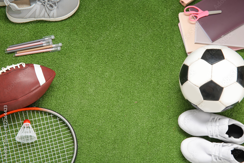 Sneakers with sport equipment and different stationery on color background