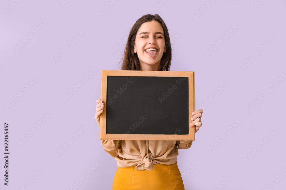 Female teacher with chalkboard showing tongue on lilac background