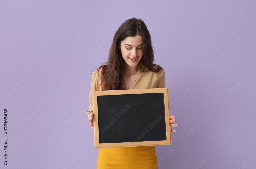 Female teacher with chalkboard on lilac background