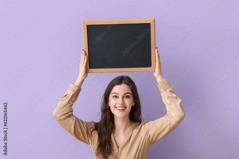 Female teacher with chalkboard on lilac background