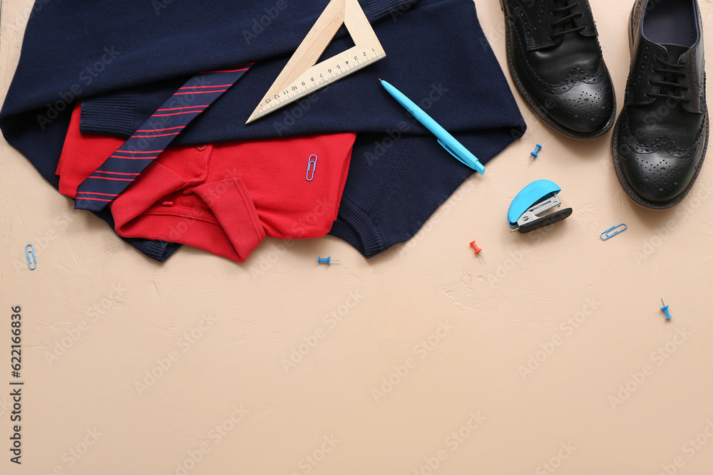 Different stationery with stylish school uniform on beige background