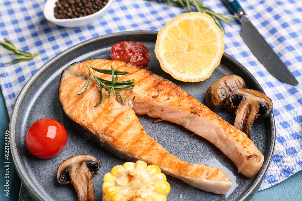 Plate with tasty grilled salmon steak on table