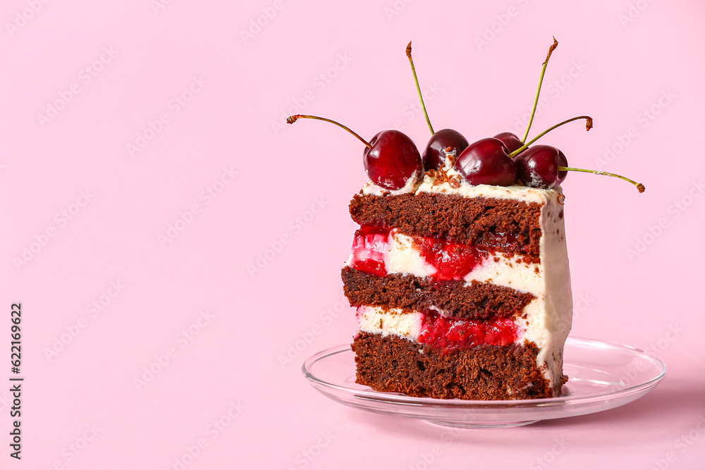 Plate with piece of tasty cherry cake on pink background