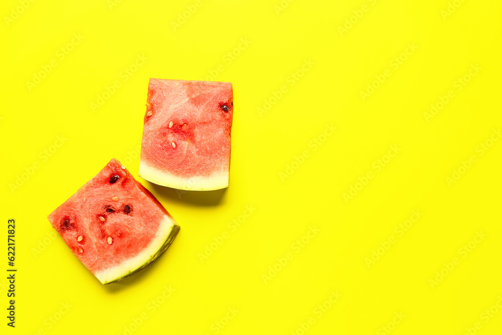 Pieces of fresh watermelon on yellow background