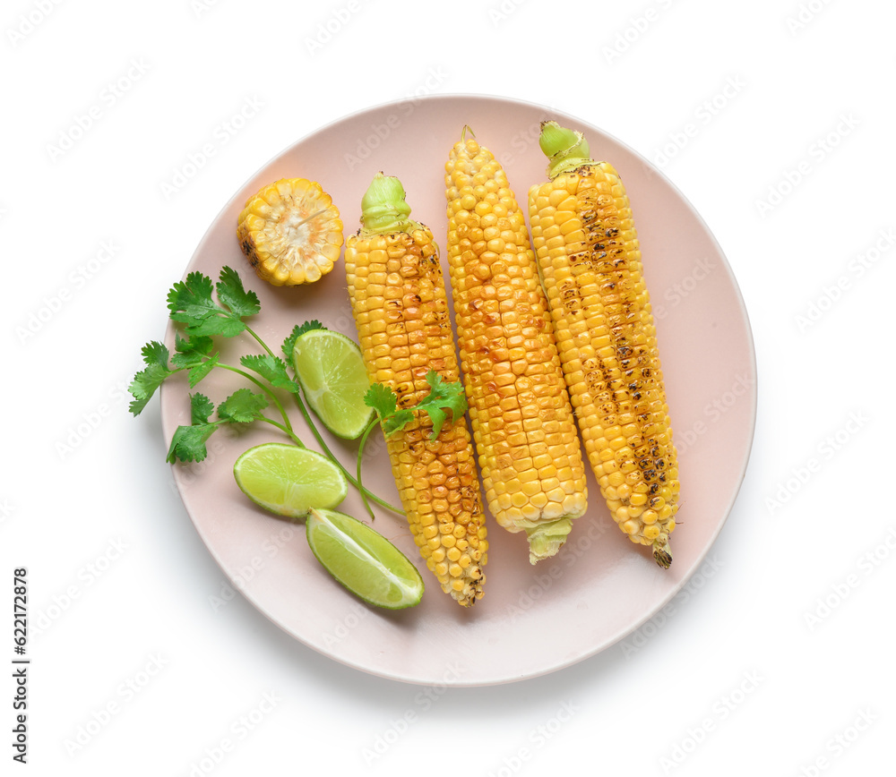 Plate with tasty grilled corn cobs and lime on white background