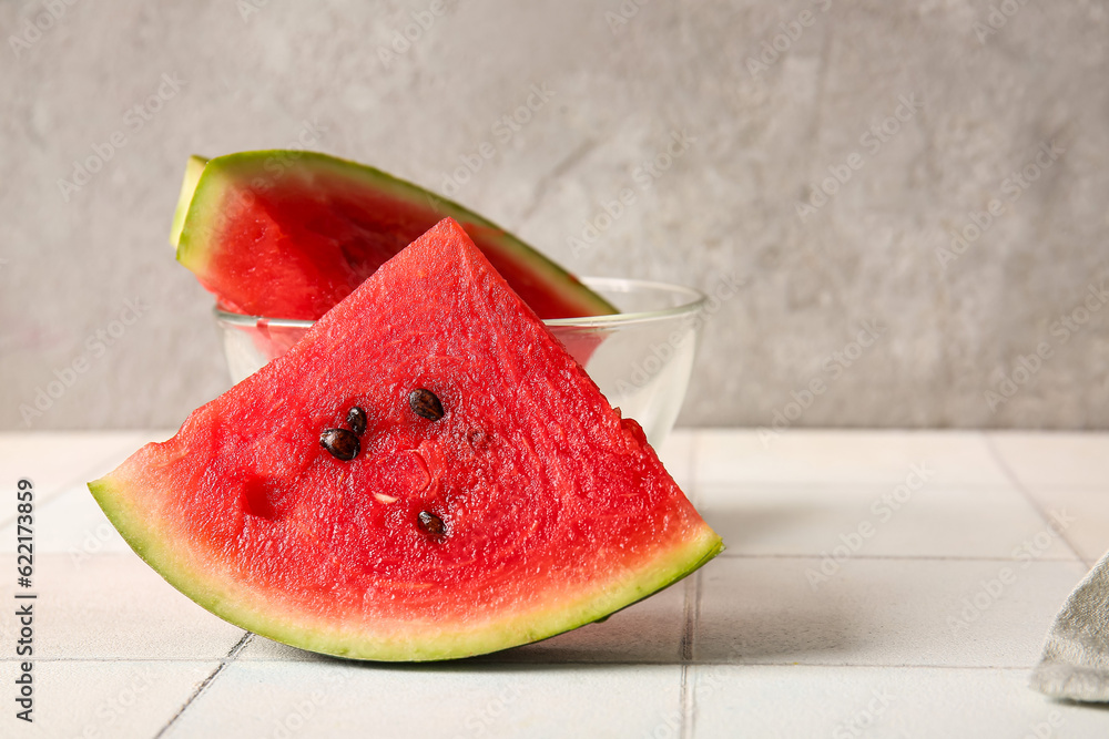 Piece of fresh watermelon on white tile table