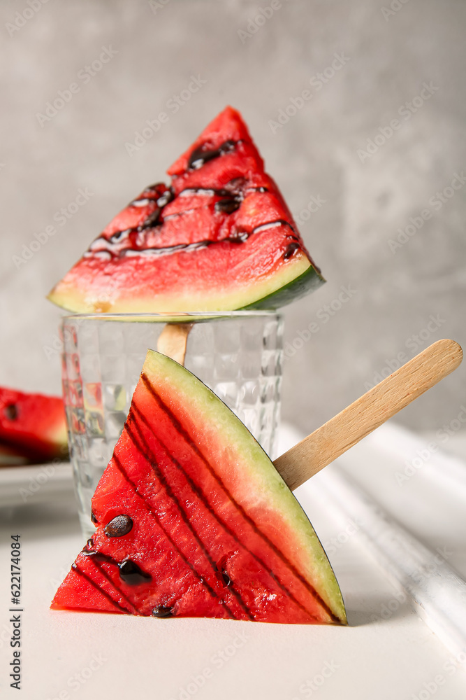 Sweet watermelon sticks on white table