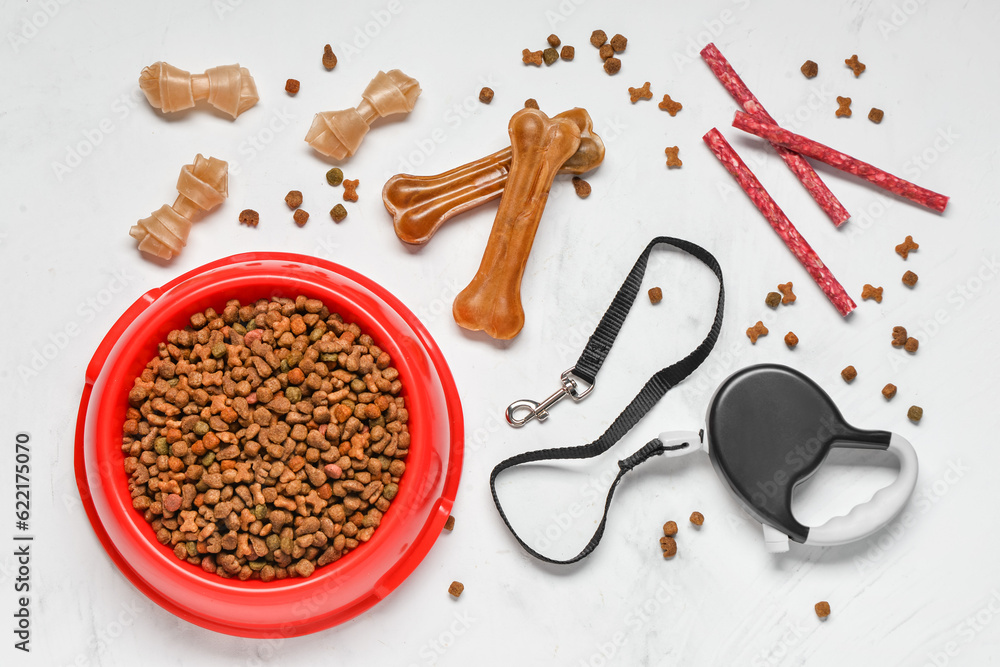 Composition with different dog food and leash on light background