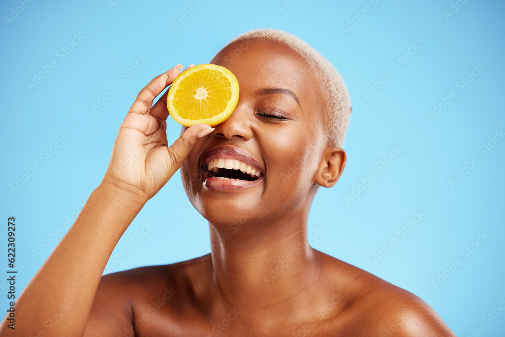 Orange, beauty and funny with a model black woman in studio on a blue background for natural nutriti