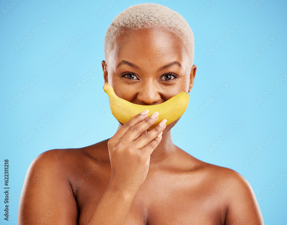 Black woman, banana and mouth for potassium, vitamin or fiber against a blue studio background. Port