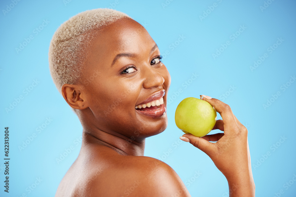 Happy black woman, portrait and apple for diet, nutrition or health and wellness against a blue stud