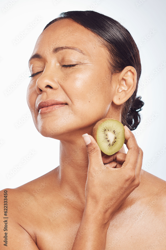 Relax, beauty or mature woman with kiwi for healthy detox, skincare or facial treatment routine in s