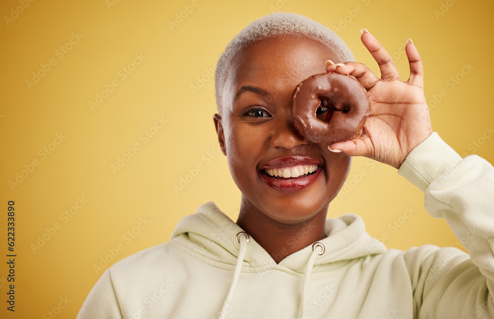 Portrait, chocolate and donut with a black woman in studio on a gold background for candy or unhealt