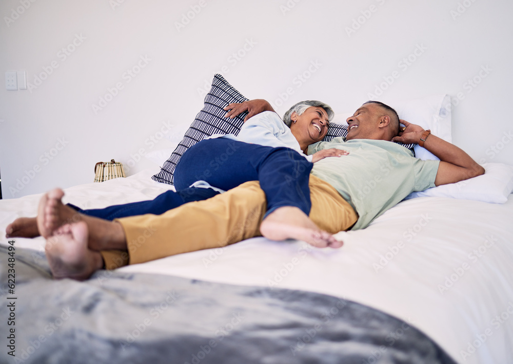 Bed, relax and happy elderly couple laughing, resting and enjoy time together, cuddle and retirement