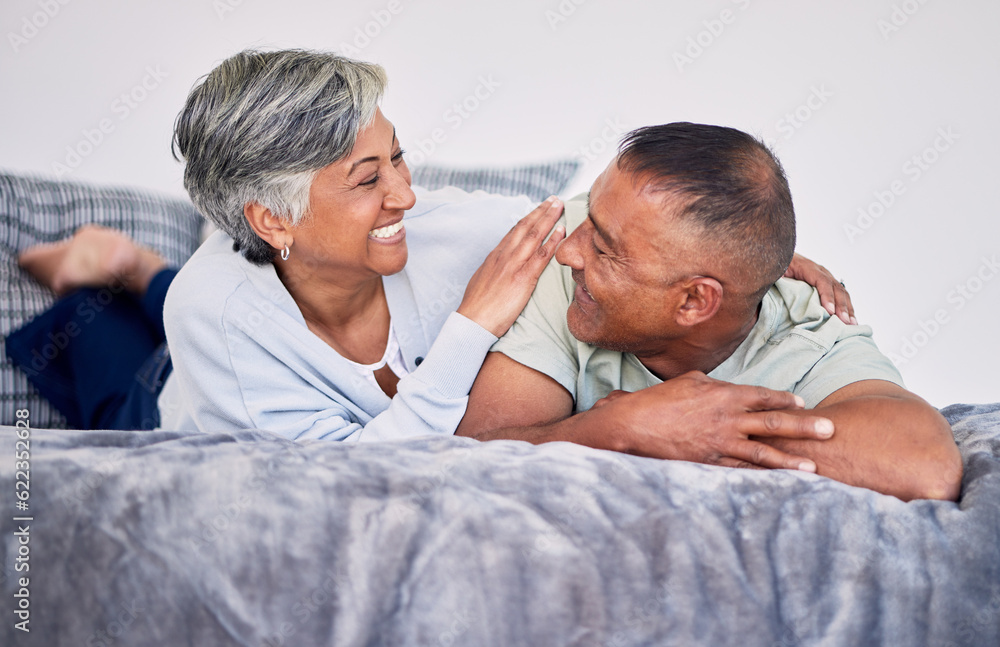 Love, conversation and mature couple on their bed while relaxing, bonding and spending time together