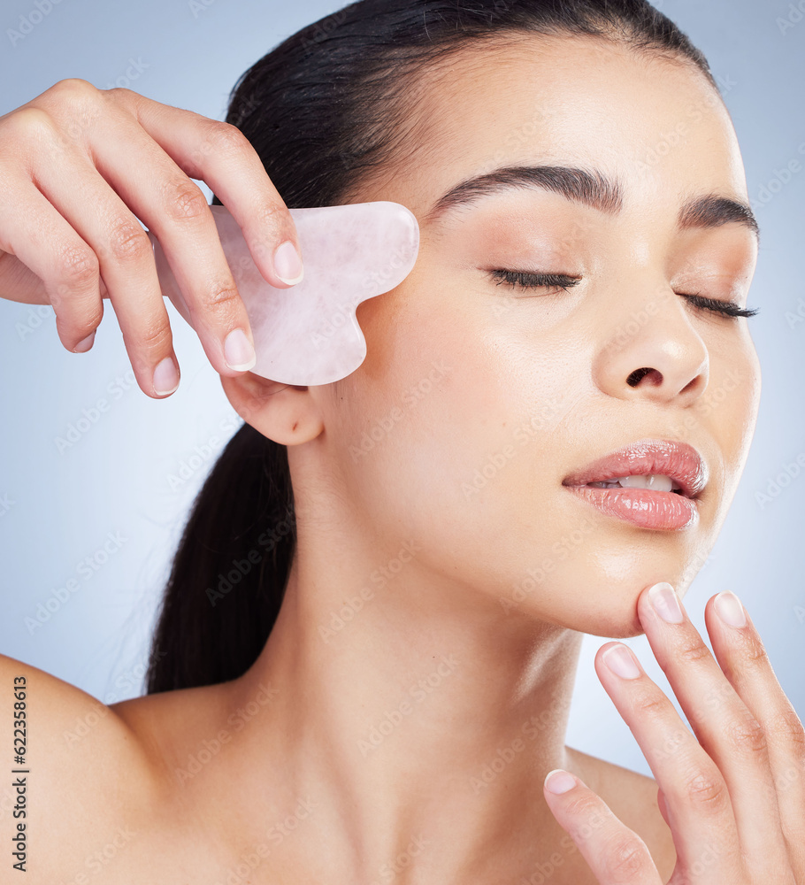 Gua sha, massage and asian woman with skincare tool in studio for anti aging, circulation or fine li