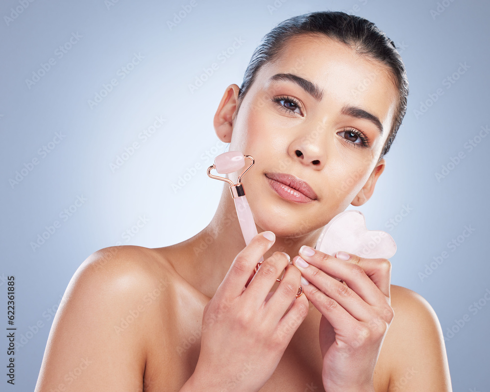 Beauty, facial roller and skin portrait of a woman in studio with skincare tools for natural glow. F