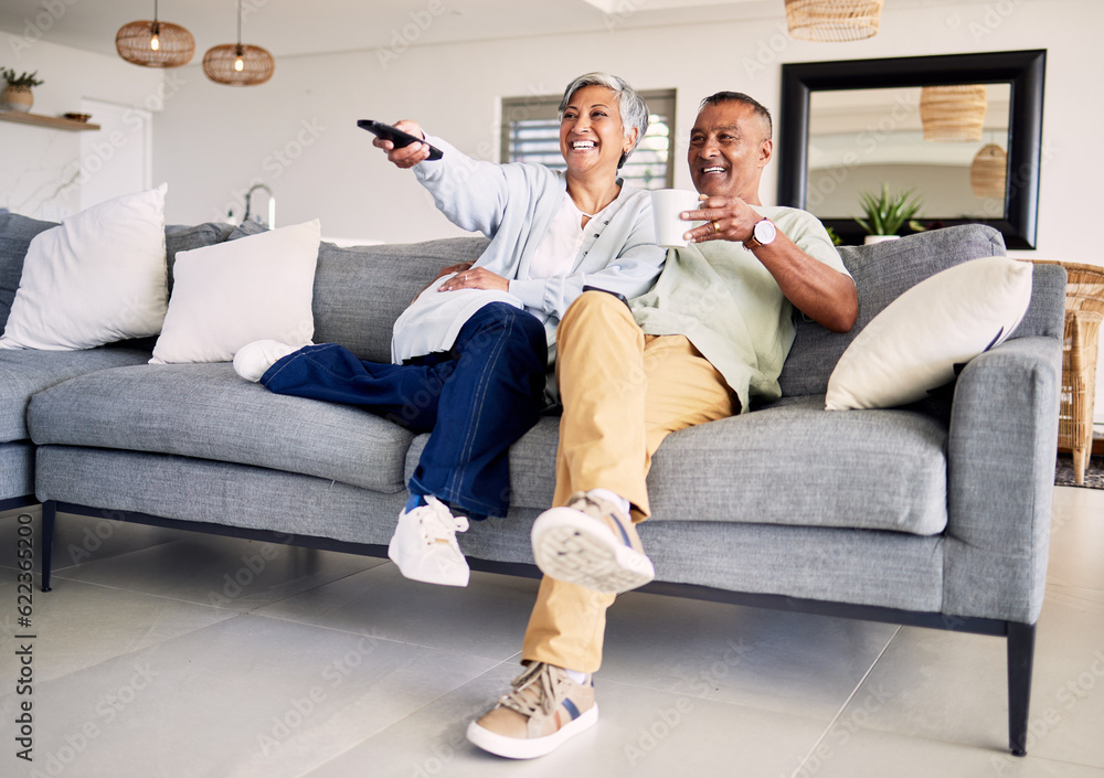 Senior couple, watching tv and remote on sofa in home living room, laughing and smile for funny come