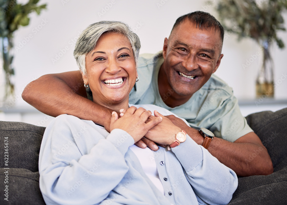 Portrait, happiness and senior couple on sofa with hug for quality time in living room to relax. Smi