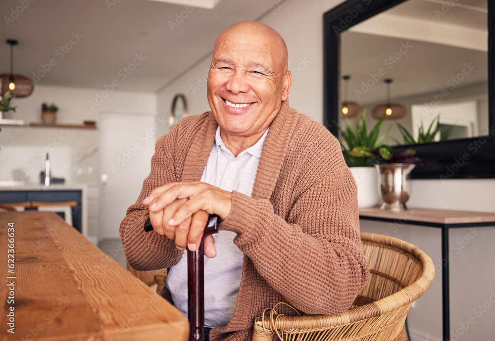 Portrait, walking stick and a senior man with a disability sitting in the living room of his home du