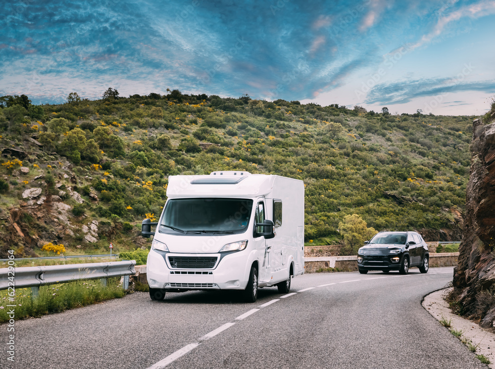 White Colour Motorhome Car Goes On Road On Background Of Spanish Mountain Nature Landscape. Cataloni