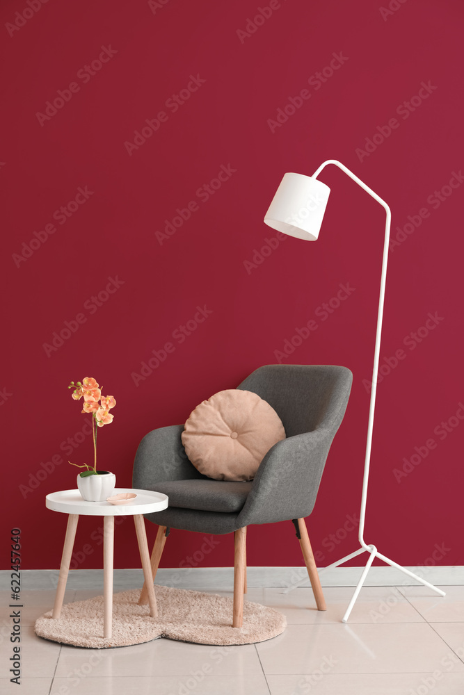 Interior of stylish living room with black armchair, table and standard lamp