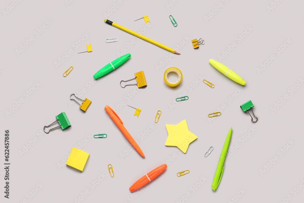 Composition with stationery supplies on grey background