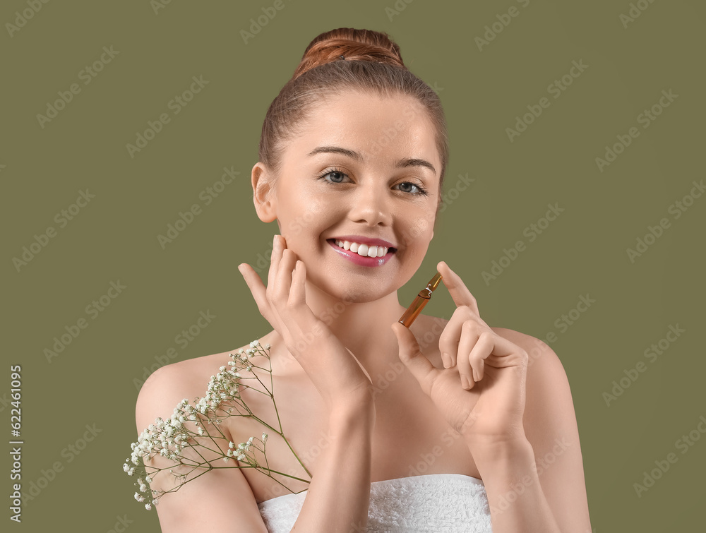 Beautiful young woman with ampule and flowers on color background. Skin care concept