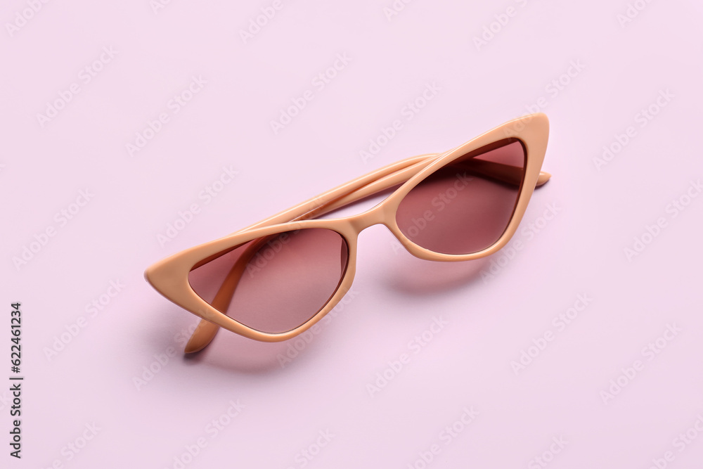 Stylish eyeglasses on pink background