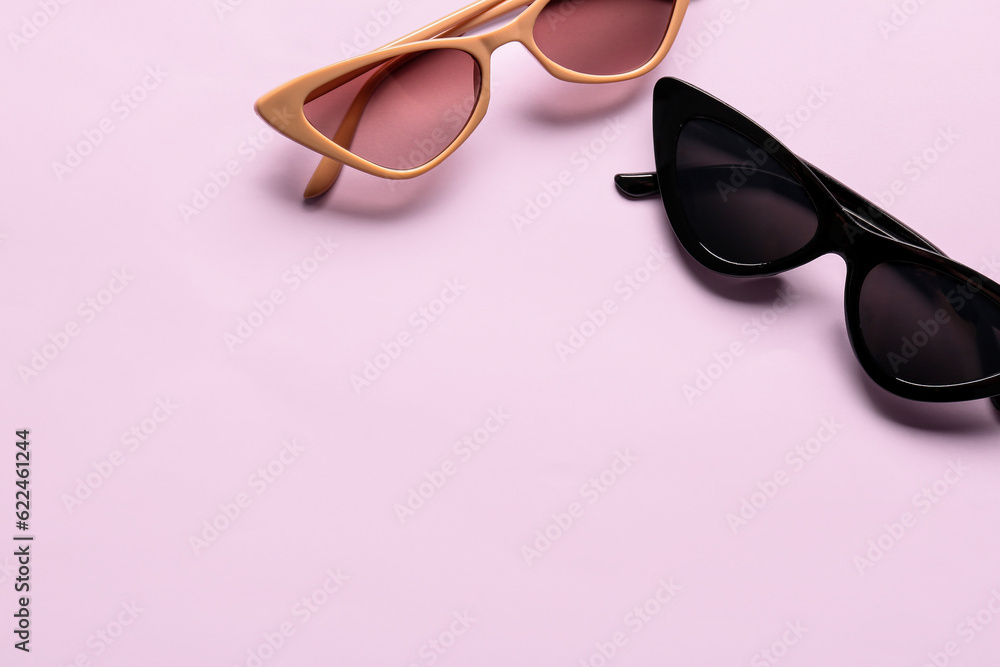 Stylish eyeglasses on pink background