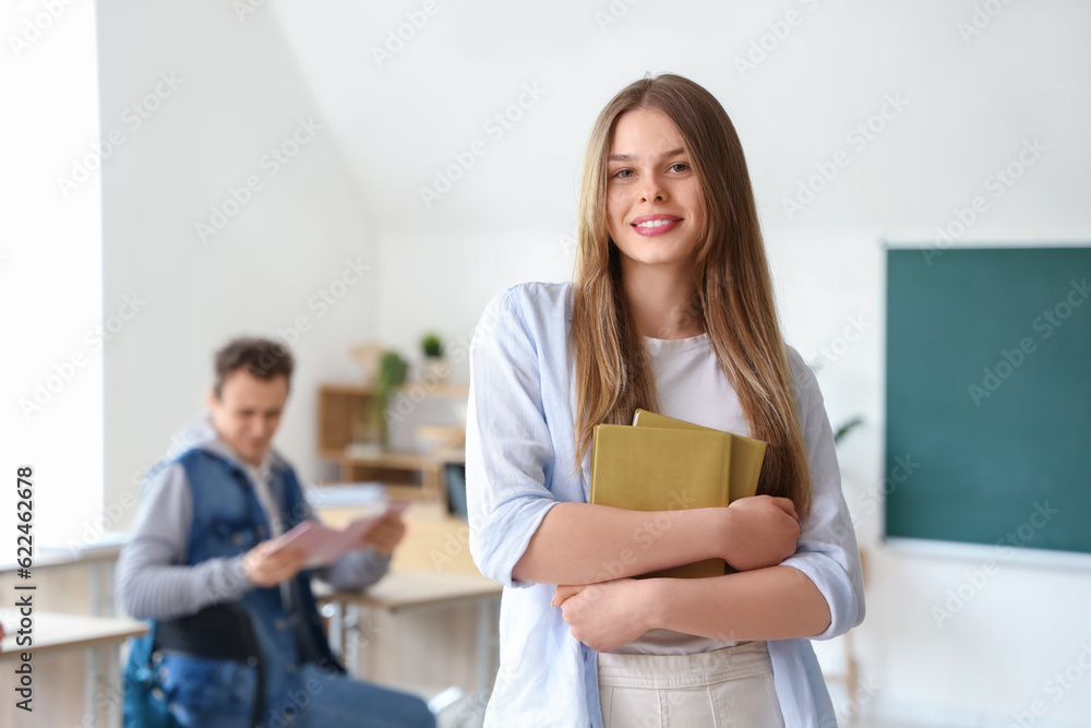 Female student with books in classroom