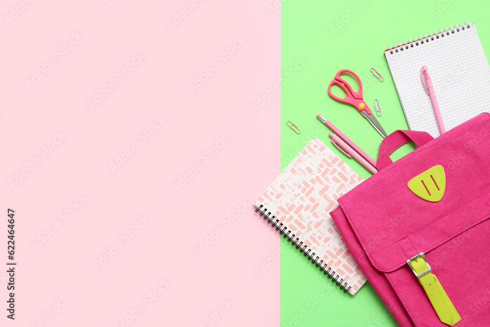 School backpack, notebooks and stationery on color background