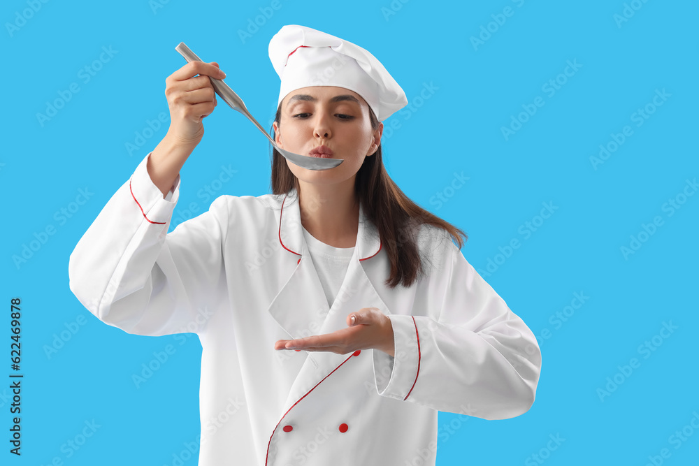 Female chef with ladle on blue background