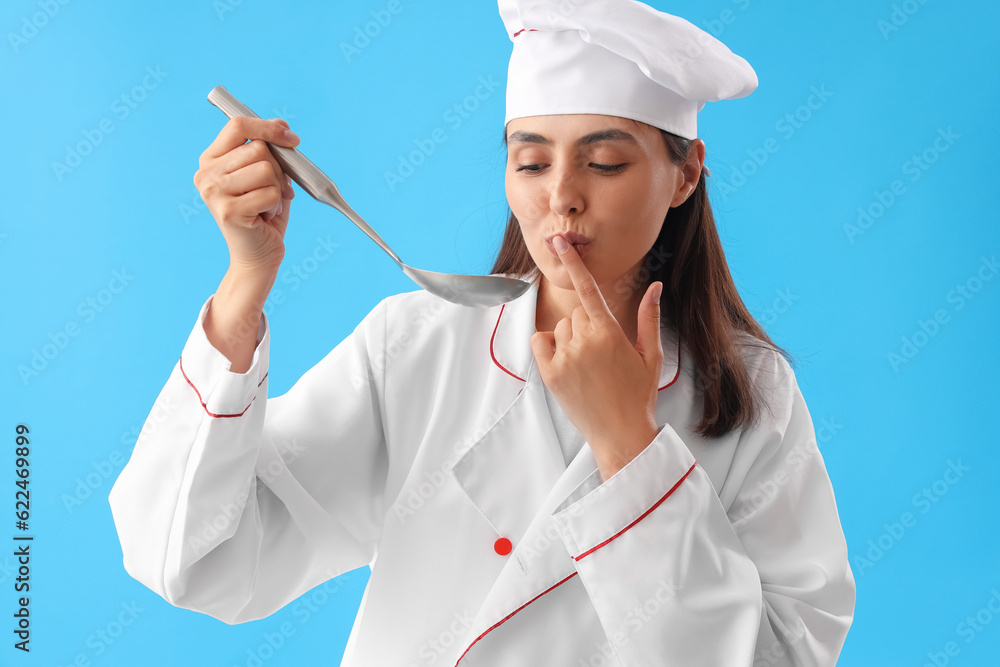 Female chef with ladle on blue background