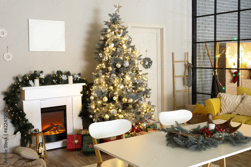 Interior of living room with Christmas tree, fireplace and dining table