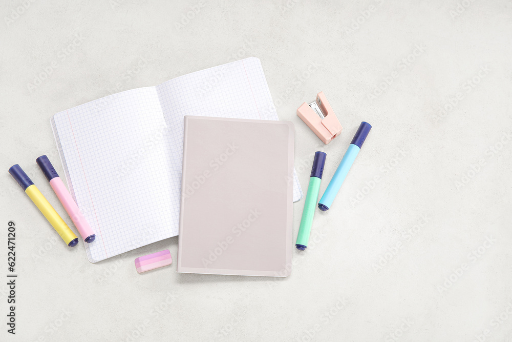 Notebooks with different stationery on beige background