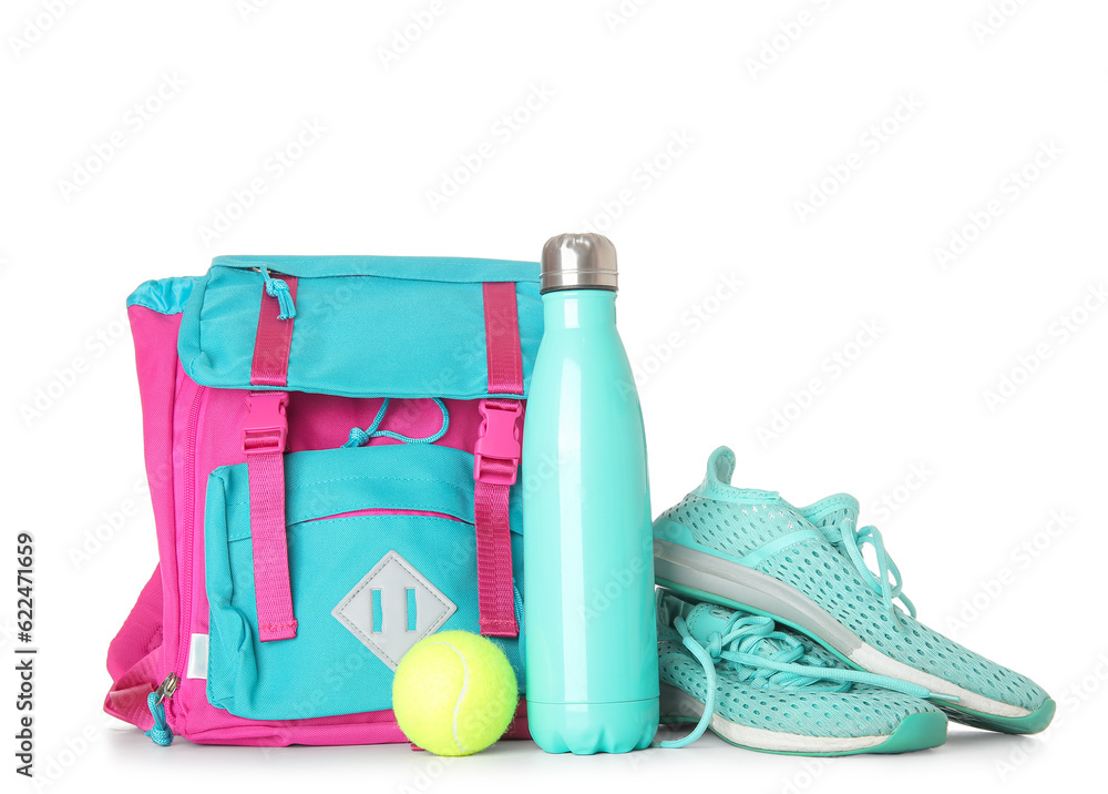 Backpack with sneakers, tennis ball and bottle of water isolated on white background