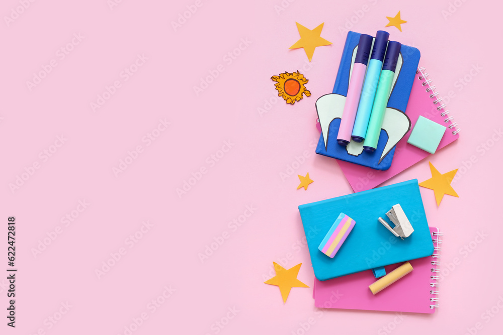 Creative composition with paper rocket and different stationery on pink background