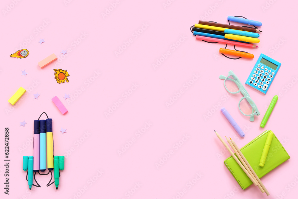 Creative composition with drawn rockets and different stationery on pink background