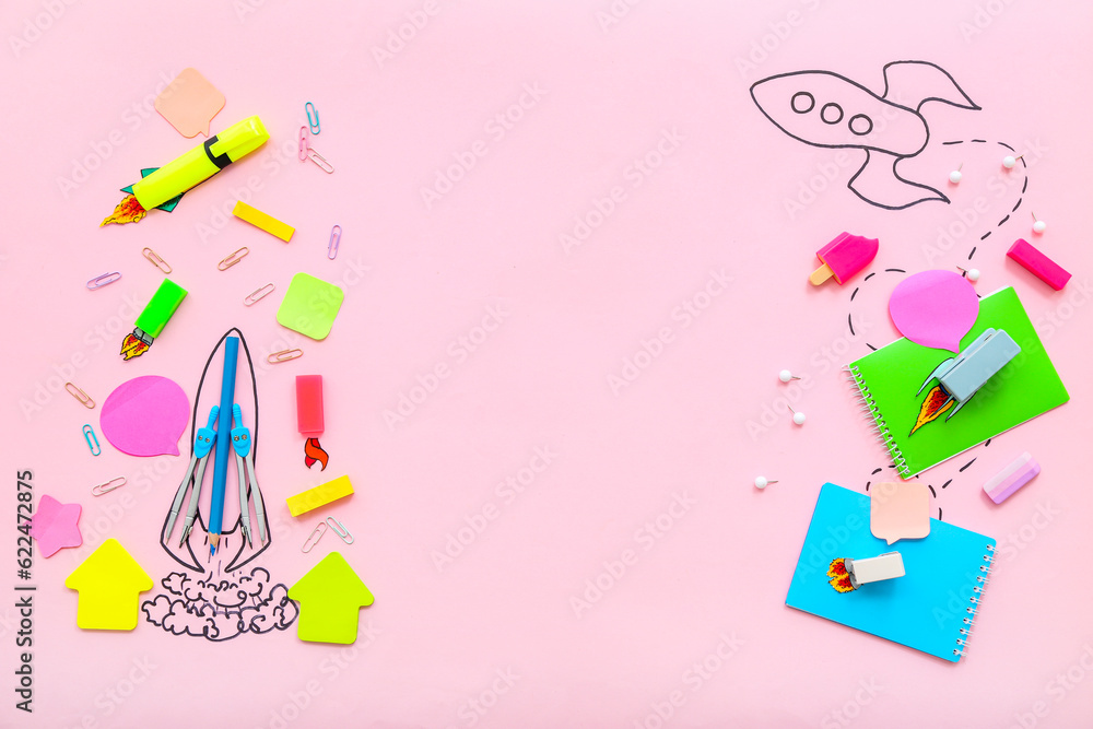 Creative composition with drawn rockets and different stationery on pink background